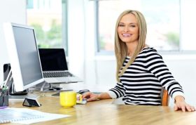 A woman working at a desk with a computer, representing the Accounting and Bookkeeping Bundle course.