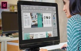 A woman focused on her computer, using Adobe software, representing the Adobe InDesign Online Course.