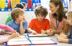 Woman helping child with homework, representing the CACHE Level 3 Award in Supporting Teaching and Learning in a nurturing environment