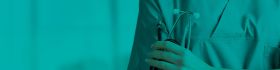 Person in a blue gown holding a stethoscope, symbolizing healthcare practice, representing the Catheterisation Online course.