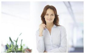 Smiling woman in a shirt looking at camera, representing the Certified Information Systems Security Professional CISSP course for cybersecurity skills.