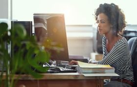 Female employee working on PC, representing the CIMA Accredited Sage Certificate Course in accounting software.