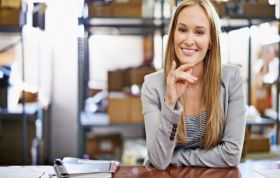 Smiling woman seated at desk, representing Citrix Xen Training Bundle course for virtualization and IT management skills