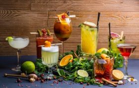 Colorful cocktails with garnishes on a dark table, representing the Cocktail - Top Tips and Standards Online Course