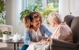 A woman converses with an elderly woman, demonstrating effective communication in the Communication Awareness Online Course.