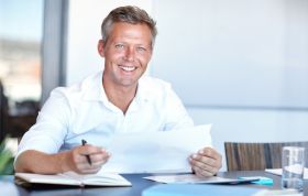 Man in a white shirt smiling warmly at the camera, representing the Configuring Advanced Windows Server 2012 Online course.