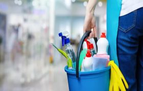 Man holding a bucket of cleaning supplies, representing COSHH in a Food Environment course to ensure safe handling of chemicals.
