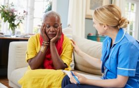 Nurse conversing with an elderly woman, representing the Dementia - Dealing With Challenging Behaviour Online course for caregiving skills.