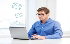Man sending emails from laptop, showcasing proper Email Etiquette to professionally interact with customers in the workplace.
