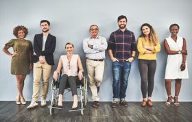 Group of diverse people, including a woman in a wheelchair, representing Equality and Diversity and promoting knowledge and understanding.
