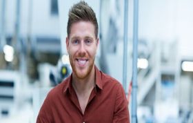 Bearded man in red shirt smiling at camera, representing the Ethical Hacker course for cybersecurity and ethical hacking fundamentals.