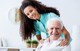 Woman caring for an elderly man, representing Level 3 End of Life Care, focusing on compassionate care and treatment.