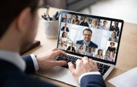 Man engaged in an online meeting on laptop, demonstrating effective Managing Home Workers and managing a remote workforce.
