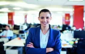 Woman in a business suit smiling warmly, representing success and approachability, for the MCSA: Querying Microsoft SQL Server 2012 with Practice Lab course.