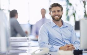 A bearded man in a blue shirt smiles warmly, representing the Microsoft: Implementing Advanced Window Server 2012 (Exam 70-414) course.