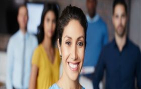 Smiling woman with colleagues, representing the Microsoft Word 2016 Course, designed to improve document creation and editing skills.