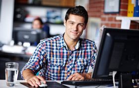 Confident man seated at desk, representing the Oracle Database 12c SQL Fundamentals Online Course for essential database training.