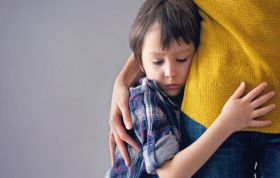 A woman cradles a child in her arms, showcasing care, representing the Safeguarding Children Practice Level 3 Online Course.