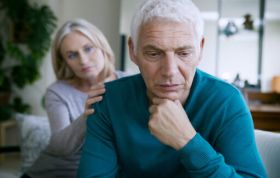 A woman supports a man with dementia, representing the Understanding Dementia course and how to work with people with dementia.